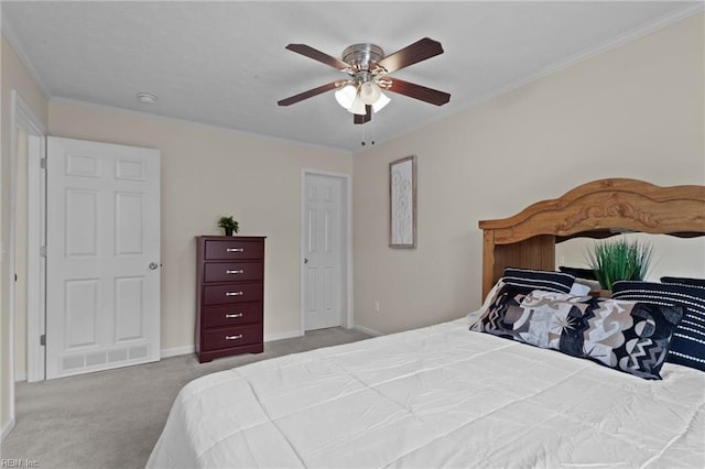 carpeted bedroom featuring crown molding and ceiling fan