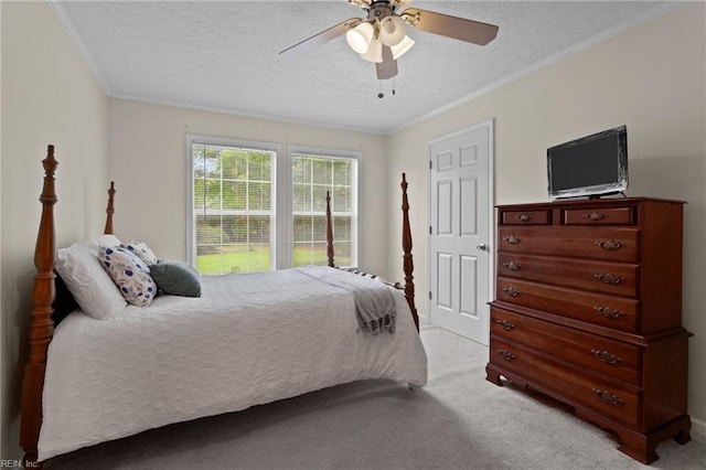 bedroom featuring light carpet, ceiling fan, crown molding, and a textured ceiling