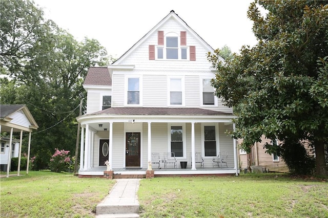 view of front of home featuring covered porch and a front lawn