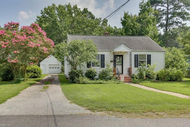 view of front of house with a garage, an outbuilding, and a front yard