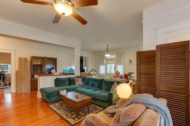 living room featuring ceiling fan and hardwood / wood-style floors