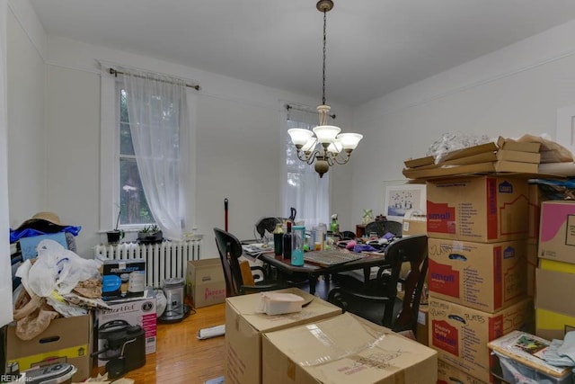 interior space featuring radiator, a notable chandelier, and hardwood / wood-style floors