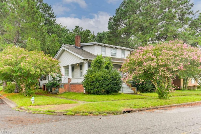 view of front of house with a porch and a front lawn