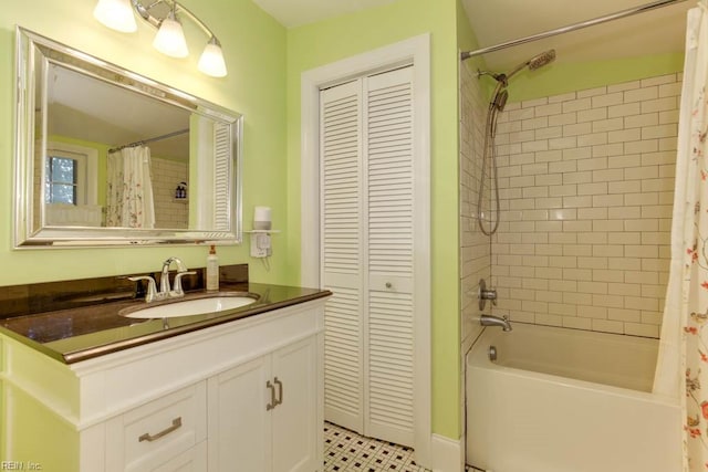 bathroom featuring shower / bath combo with shower curtain, tile patterned floors, and vanity