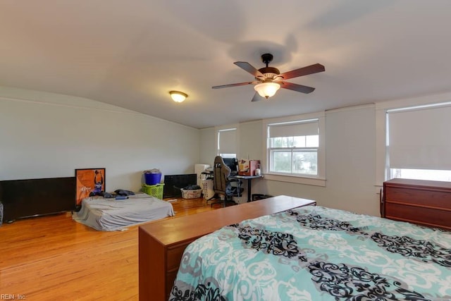 bedroom featuring light hardwood / wood-style flooring, ceiling fan, and lofted ceiling