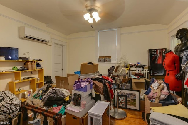 miscellaneous room featuring a wall mounted air conditioner, ceiling fan, and hardwood / wood-style floors