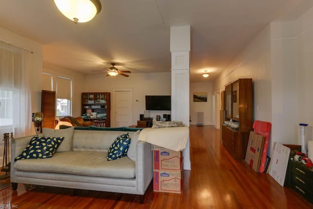 living room with radiator heating unit, ceiling fan, and wood-type flooring