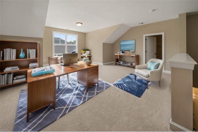 carpeted office with baseboards and vaulted ceiling