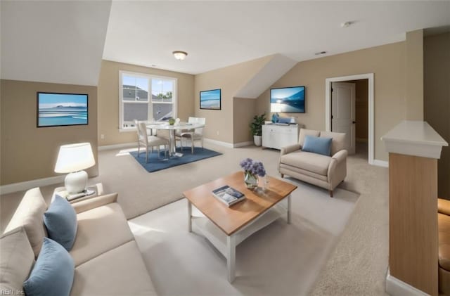 living area with baseboards and light colored carpet