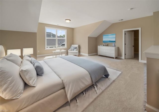 bedroom with light carpet, vaulted ceiling, and baseboards