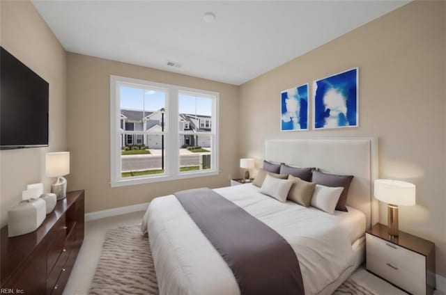 carpeted bedroom with visible vents and baseboards