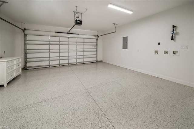 garage with baseboards, electric panel, and a garage door opener