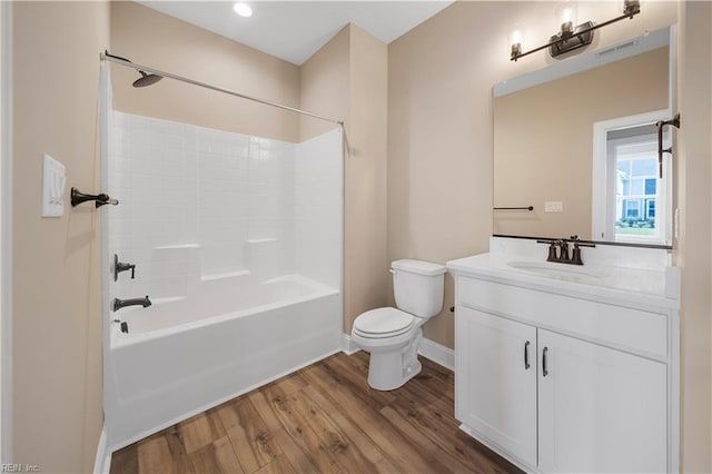 full bathroom featuring shower / bath combination, visible vents, toilet, wood finished floors, and vanity