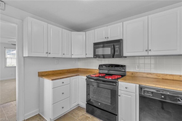 kitchen featuring black appliances, white cabinets, and light tile patterned floors