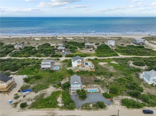 bird's eye view featuring a water view and a view of the beach