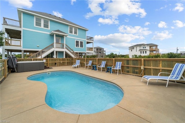 view of swimming pool with stairs, a patio area, fence, and a fenced in pool