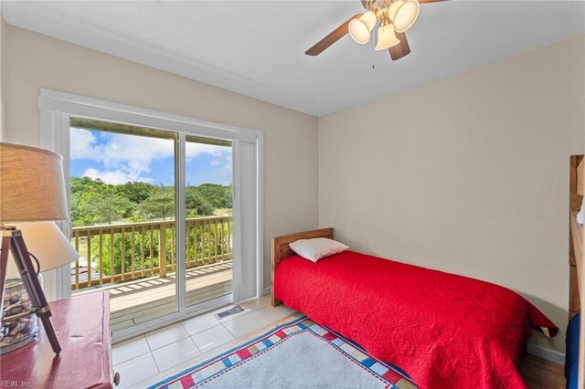 tiled bedroom with ceiling fan and access to exterior