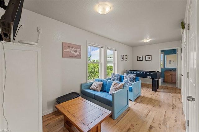 living room featuring light wood-style floors and baseboards