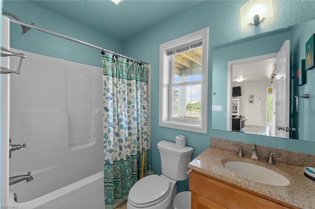 full bathroom with shower / tub combo, vanity, and toilet