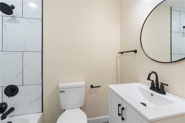 full bathroom featuring vanity, tiled shower / bath combo, and toilet