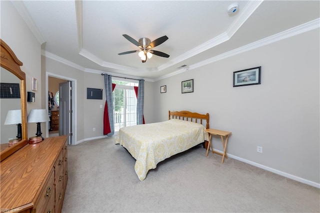 bedroom with ceiling fan, a raised ceiling, crown molding, and light carpet