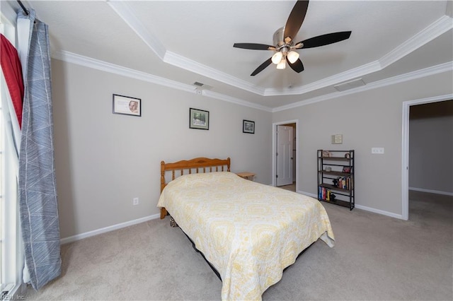 carpeted bedroom featuring ceiling fan, a raised ceiling, and crown molding