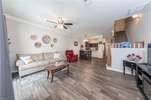 living room with ceiling fan, ornamental molding, and dark hardwood / wood-style flooring