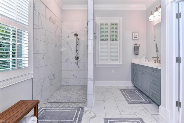 bathroom with tiled shower, crown molding, vanity, and tile patterned floors