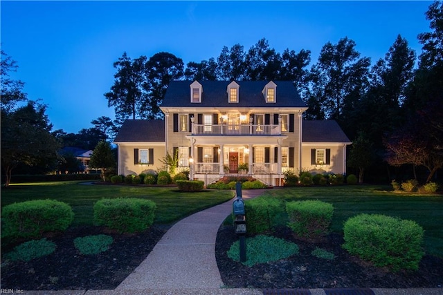 view of front facade featuring a lawn and a porch