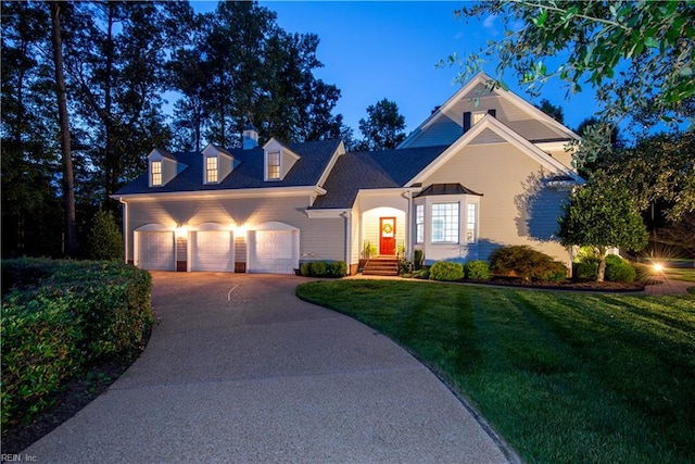 view of front of house featuring a garage and a front yard