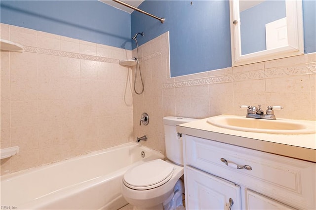 full bathroom with vanity, tasteful backsplash, tile walls, toilet, and tiled shower / bath combo