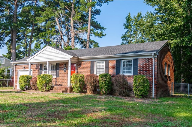 view of front of property with a garage and a front lawn