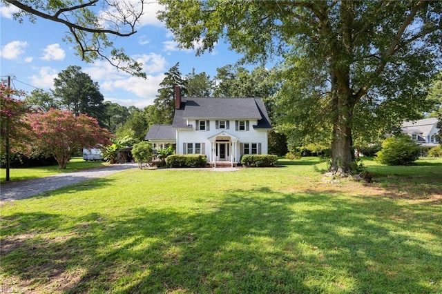 colonial inspired home with a front lawn