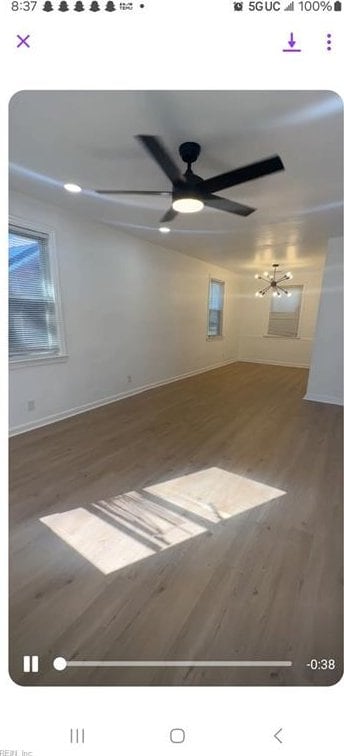 spare room with ceiling fan and wood-type flooring