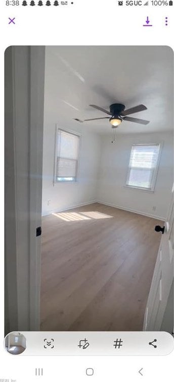 spare room with hardwood / wood-style flooring and ceiling fan