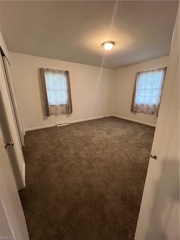 carpeted empty room featuring plenty of natural light