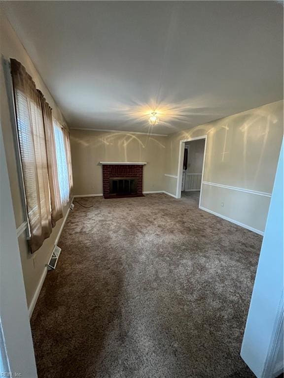 unfurnished living room with a fireplace and carpet