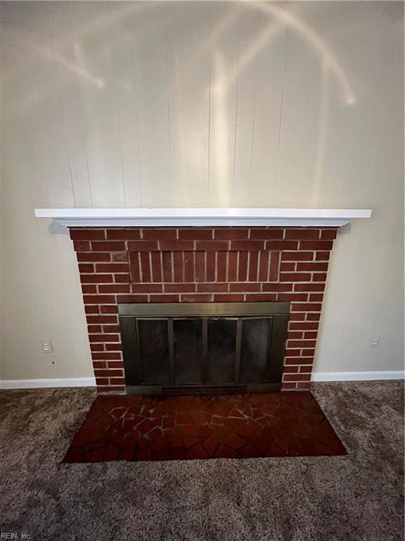 interior details featuring a brick fireplace and carpet floors