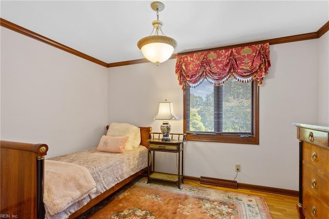 bedroom featuring crown molding and light wood-type flooring