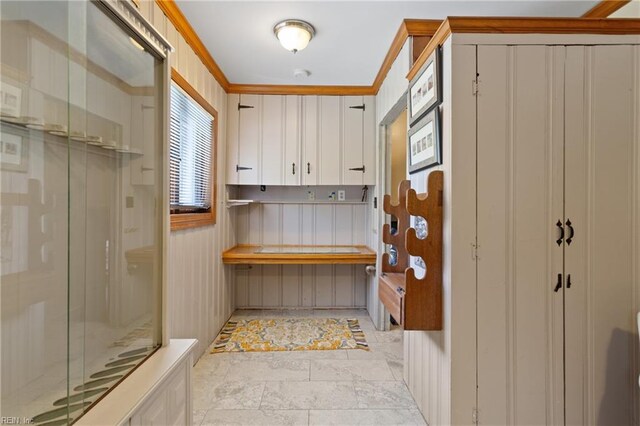 bathroom featuring tile patterned flooring and crown molding