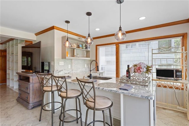 kitchen featuring light tile patterned flooring, sink, hanging light fixtures, tasteful backsplash, and kitchen peninsula