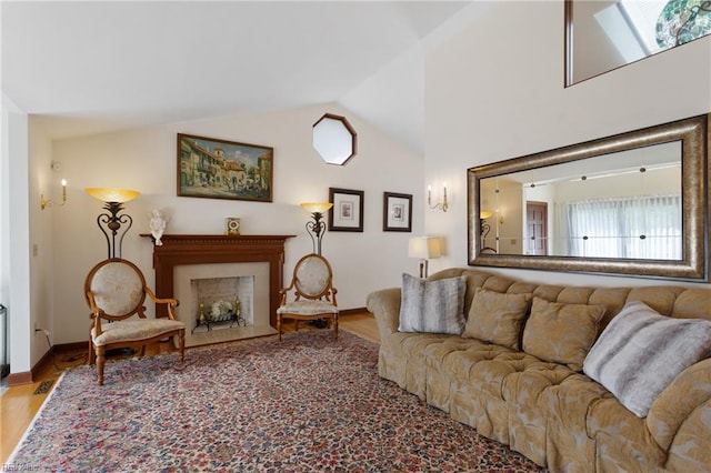 living room with high vaulted ceiling, a skylight, and wood-type flooring