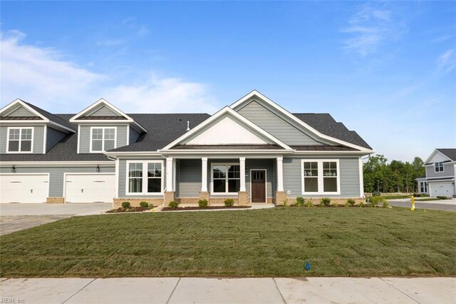 craftsman-style home with a garage and a front lawn