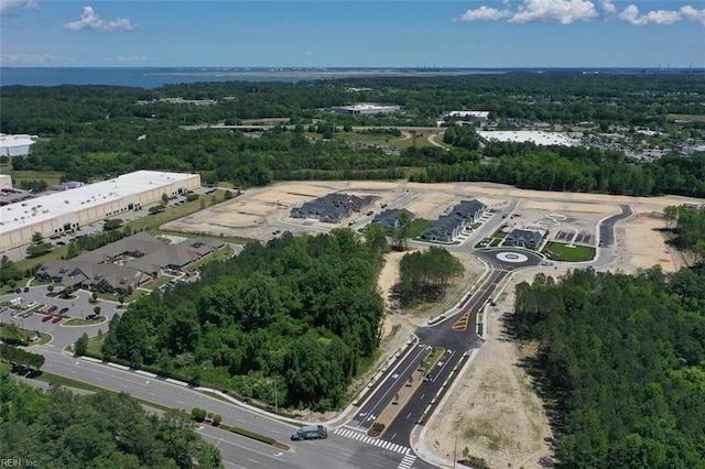 birds eye view of property featuring a wooded view