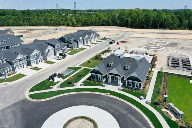 birds eye view of property featuring a residential view and a wooded view