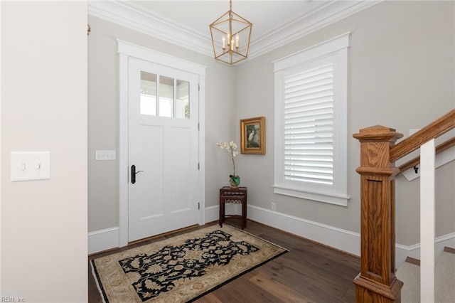 entryway with stairs, ornamental molding, plenty of natural light, and wood finished floors