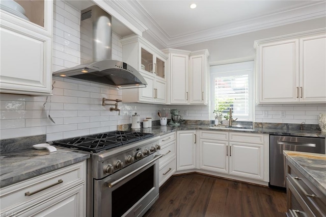 kitchen featuring crown molding, stainless steel appliances, dark wood-type flooring, a sink, and wall chimney exhaust hood