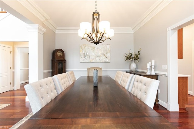 unfurnished dining area featuring a notable chandelier, crown molding, ornate columns, and dark hardwood / wood-style floors