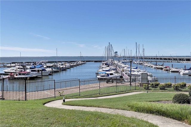 dock area featuring a lawn and a water view