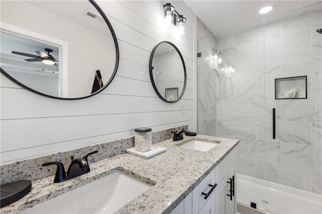 bathroom featuring vanity, walk in shower, wooden walls, and ceiling fan